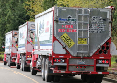 The Bark King blower truck fleet lined up at the yard