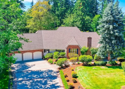 Brick home with mulched foundation beds and mature planting