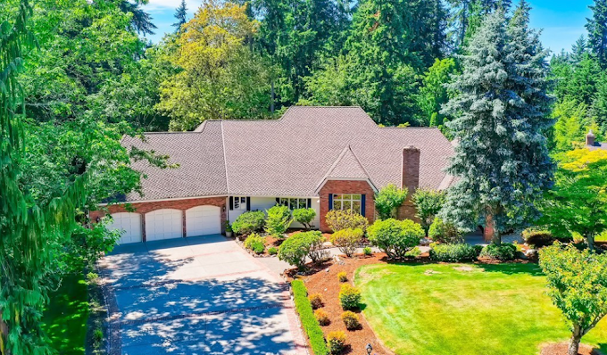 Brick home with mulched foundation beds and mature planting