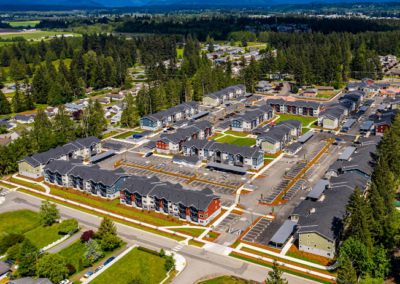 Aerial view of a multi-building residential community with landscaped common areas