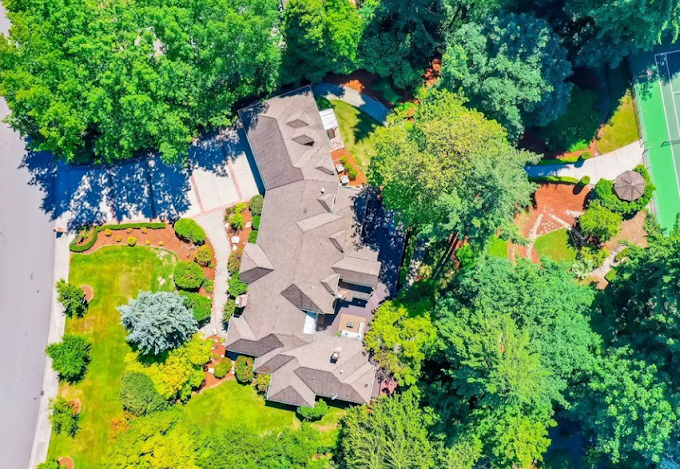 Overhead aerial view of a residential property showing bark beds laid out across the grounds